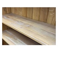 Contemporary light oak open bookcase, rectangular form with projecting top, fitted with five adjustable shelves, on a straight plinth base