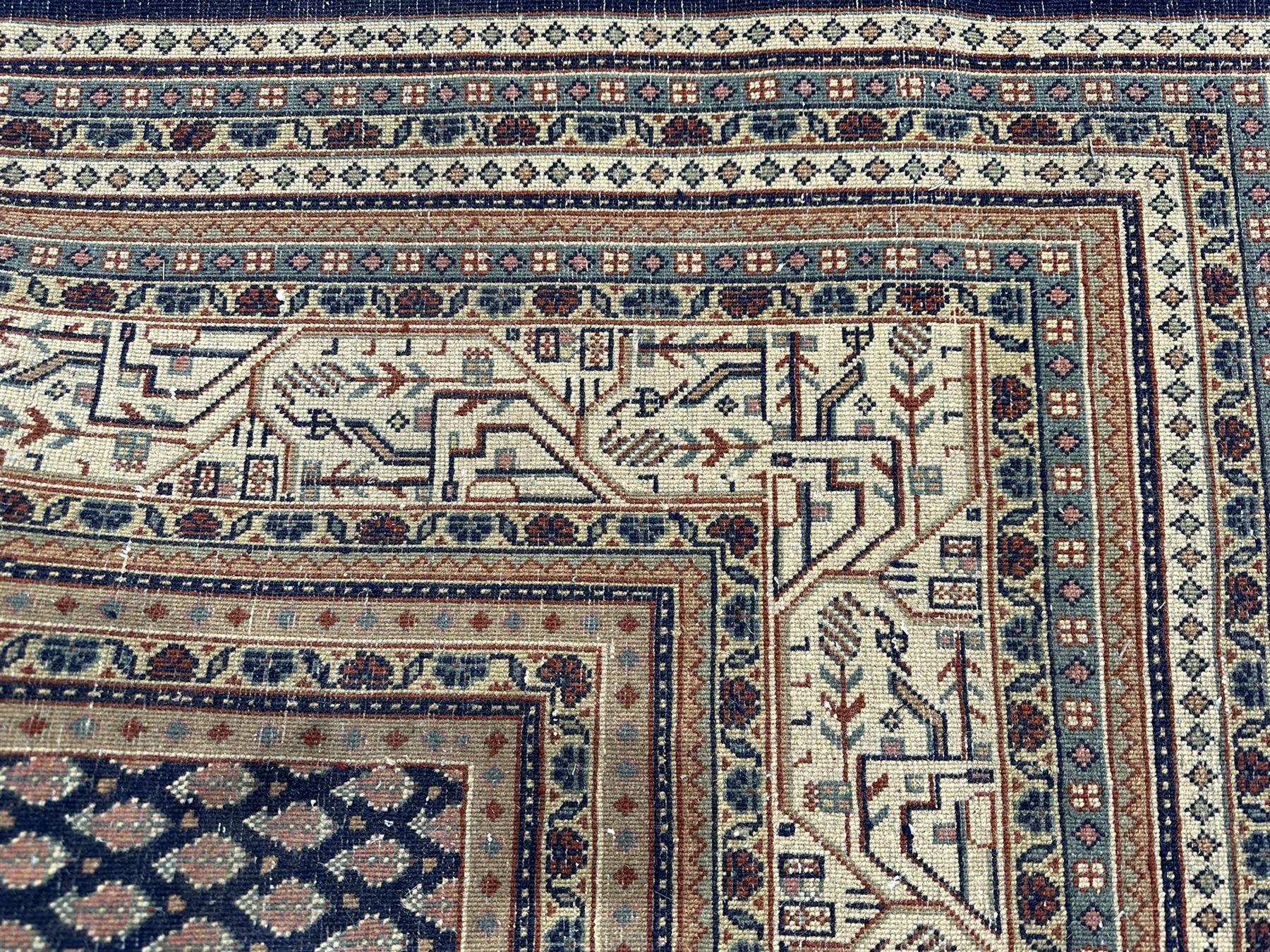 Large North-West Persian Arrak indigo ground carpet, the field decorated all-over with small Boteh motifs, multiple band border decorated with repeating geometric designs 