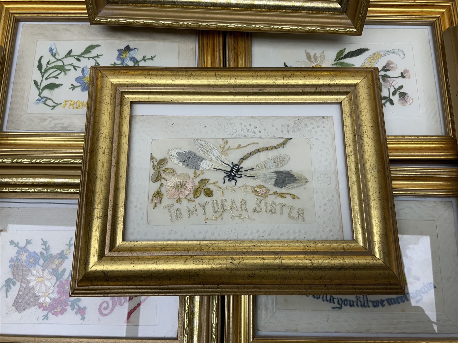 Collection of twenty eight, mostly WWI period embroidered silk greetings cards and postcards, including 'A kiss from France', good luck, sweetheart and Christmas examples, all within modern gilt frames