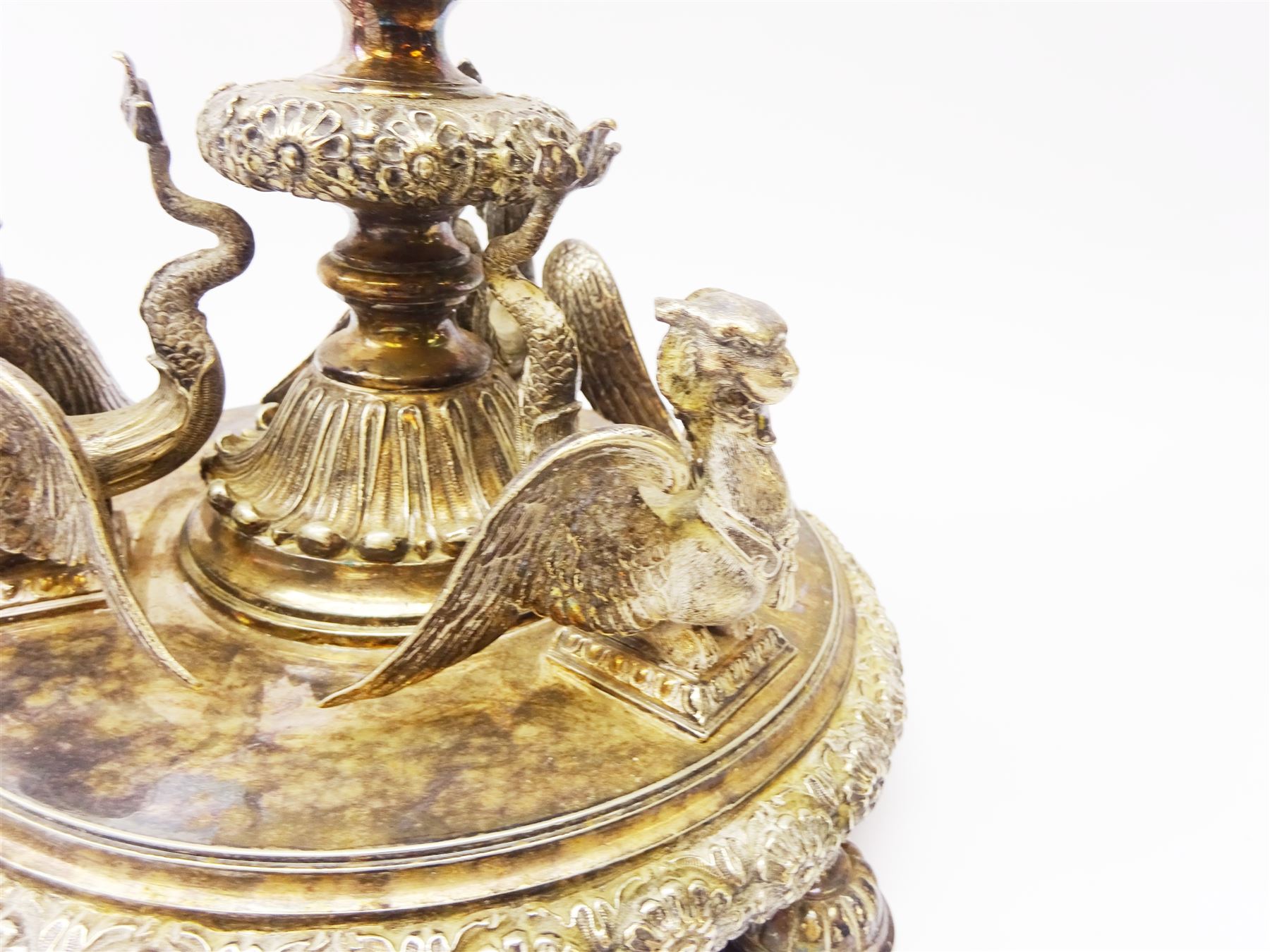 A large Victorian Thomas Bradbury & Sons silver plated candelabrum, the circular base with flower head border upon three domed feet, supporting a central knopped and fluted column flanked by three zoomorphic creatures, leading to a central socket with removable nozzle above a large palmette detailed drip pan, and three scrolling branches with conforming sockets and nozzles, with maker's silver plate mark and Victorian registration lozenge beneath, H62.5cm