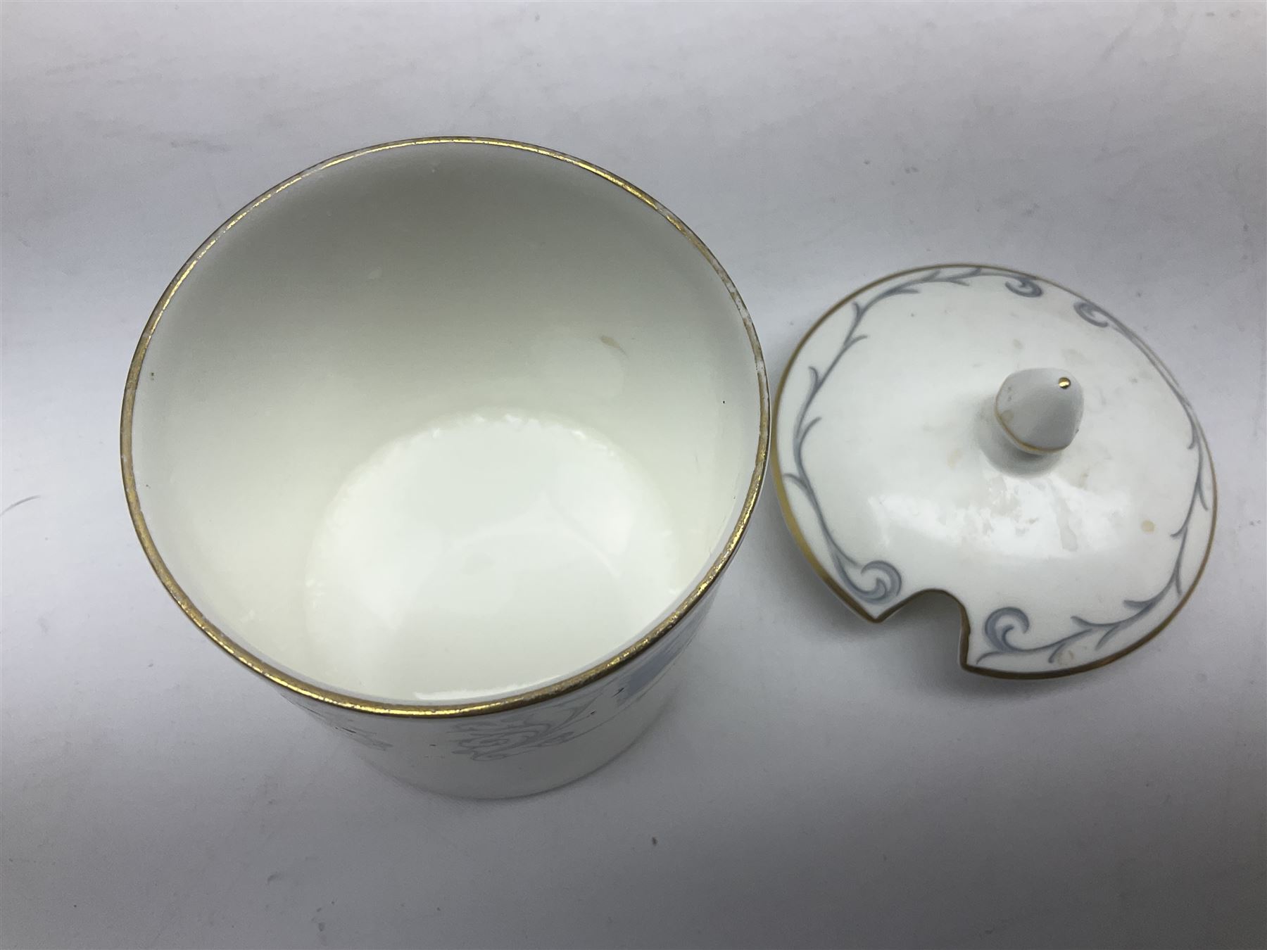 Coalport Revelry pattern tea and dinner wares, comprising nine dinner plates, four salad plates, eleven side plates, sauce boat and stand, ten teacups and ten saucers, and preserve pot and cover, together with a Coalport plate of shaped form decorated with pink roses, and a Royal Crown Derby Royal Antoinette pattern trio