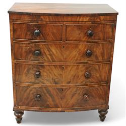 19th century mahogany chest of drawers, bow fronted form with two short over three long drawers, each veneered in matched flame mahogany, on turned feet