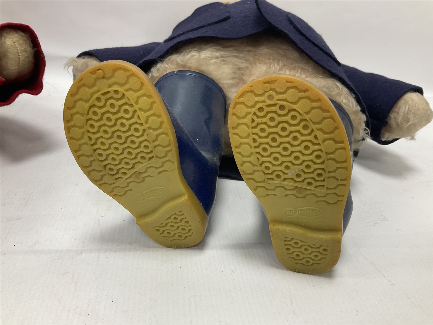 Pair of Paddington Bear teddies with amber eyes, the first example having a brown felt hat, red coat and blue PB boots with original label; the second having a grey felt hat, blue coat and blue Dunlop boots, tallest H51cm 