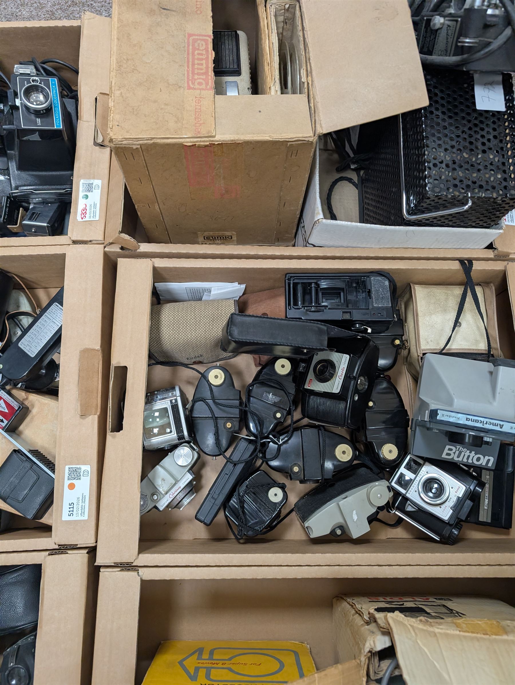 Collection of vintage cameras, projectors and accessories, including Kodak Brownies, Praktica, Polaroid, Ensign, light meters, flashes, etc