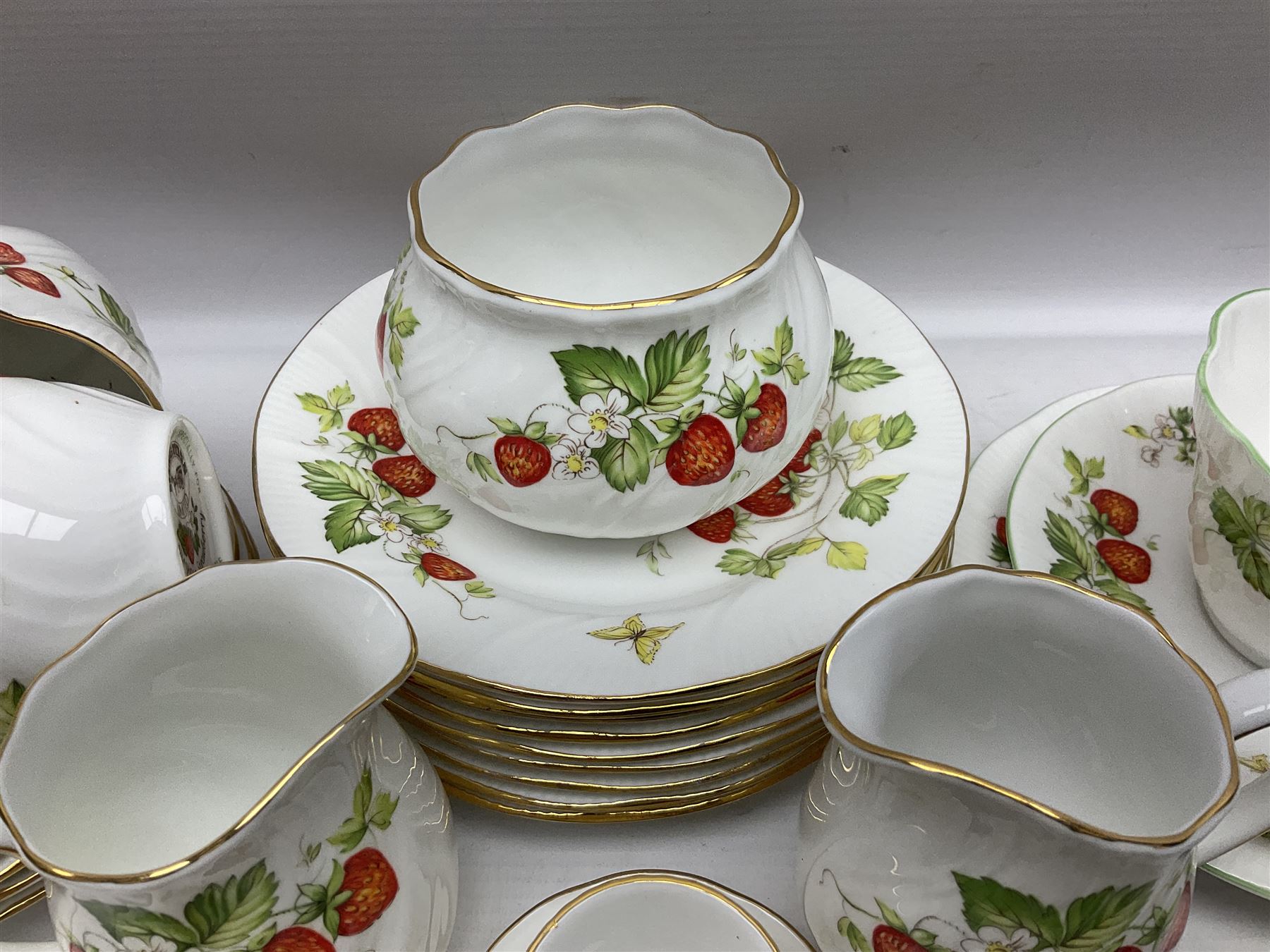 Ringtons and Queen's China Virginia Strawberry pattern teawares, including teacups, saucers, milk jugs, sugar bowls, etc