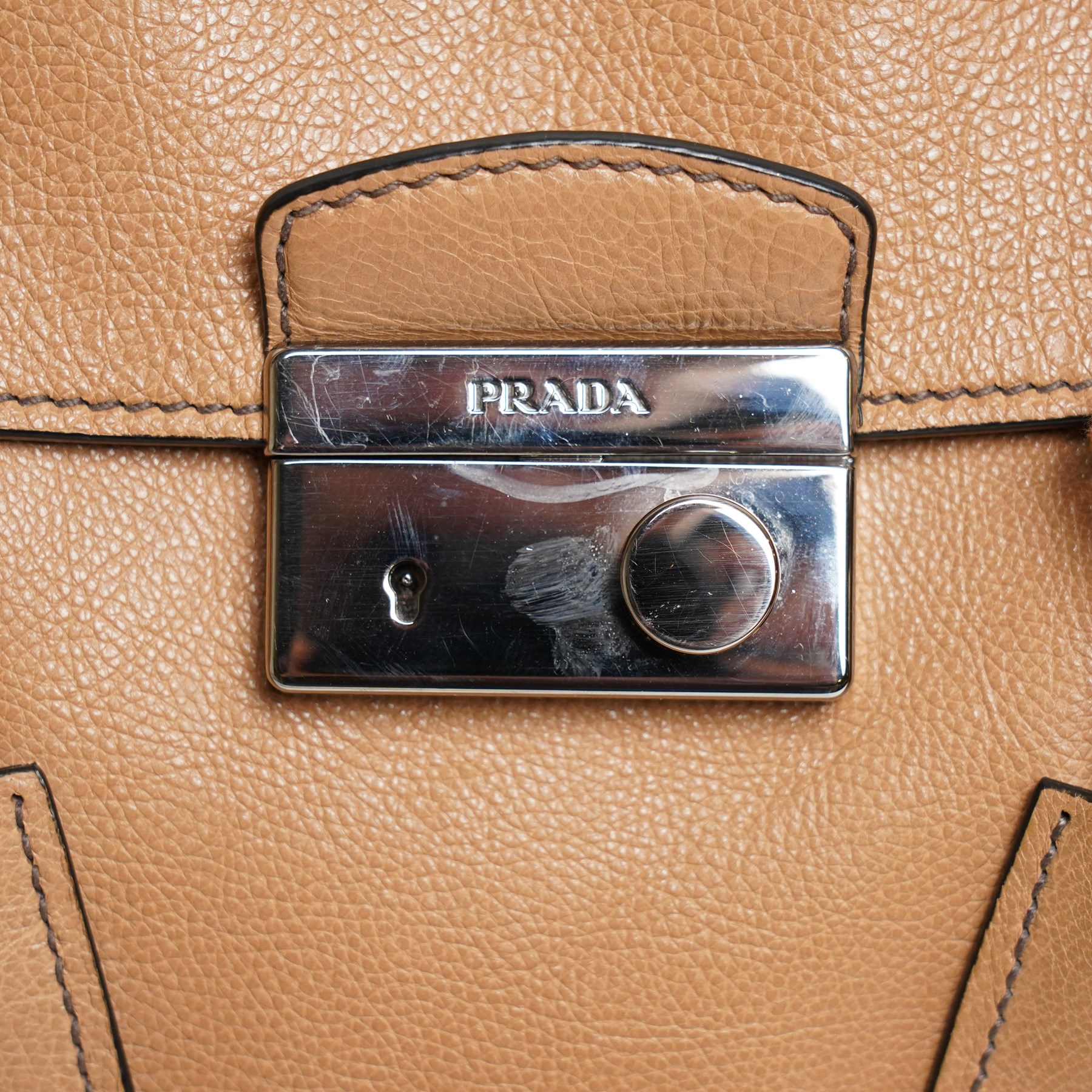 Prada - ‘Sound Lock’ satchel in Naturale Glace Calf leather, with silver-tone push-lock fastening, twin rolled handles, detachable and adjustable shoulder strap and hanging leather clochette, with original product tag, authenticity cards and dust bag