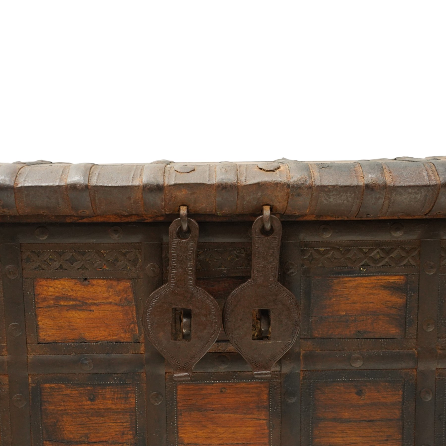 Large 19th century North Indian teak and wrought iron-bound dowry chest, probably Rajasthani, the shallow domed plank lid secured with broad iron straps above a lattice-carved frieze and grid of riveted iron bands, with twin shaped hasps, side carrying handles and fitted interior till, on bracket feet
