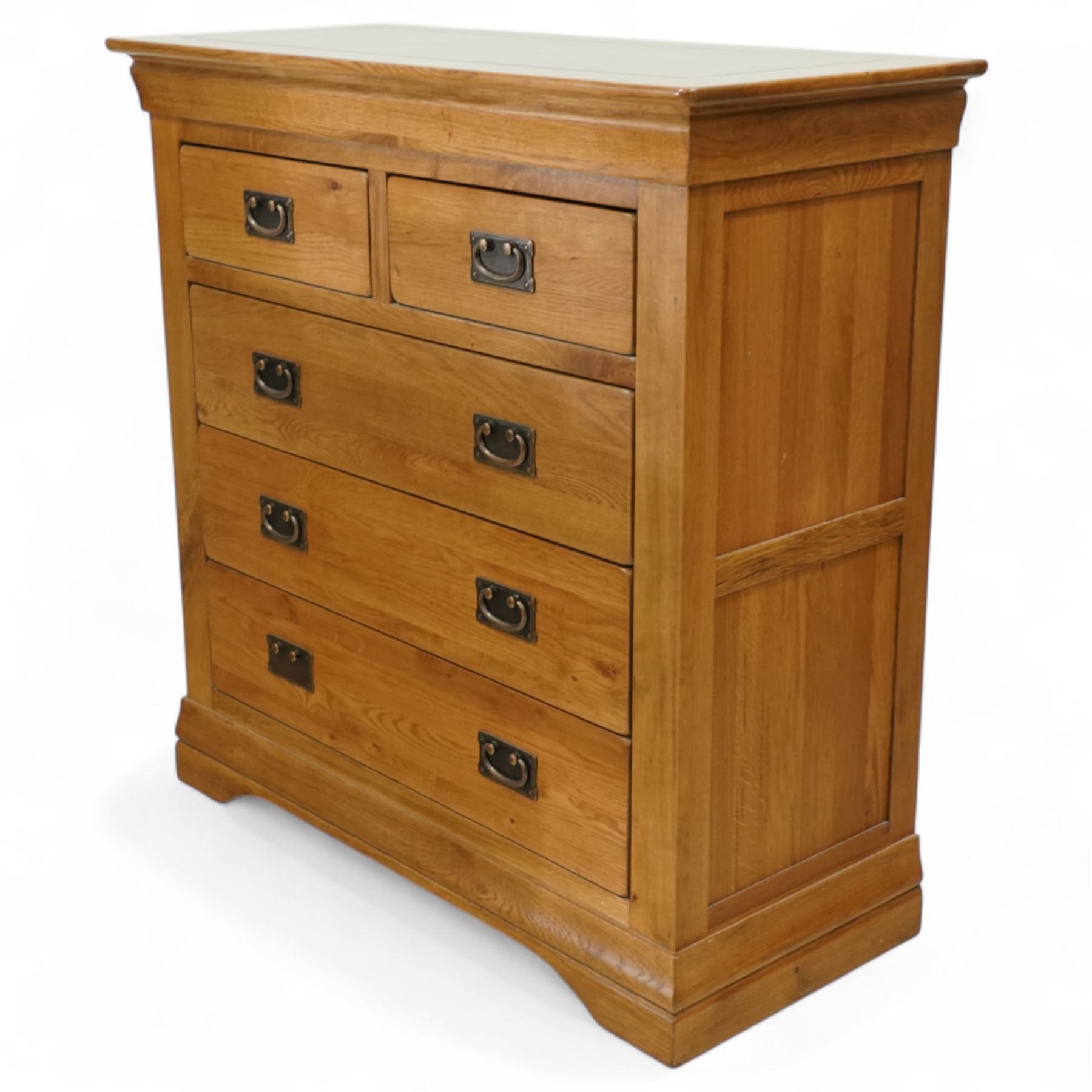 Contemporary solid oak five drawer chest, the rectangular top with inset panels over two short and three full-width drawers, all with brass-effect drop handles, raised on a plinth base