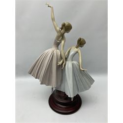 Lladro figure group, 'Merry Ballet', modelled as two ballerinas in dancing pose, raised on a turned socle base, no. 5035, printed marks beneath, H49cm
