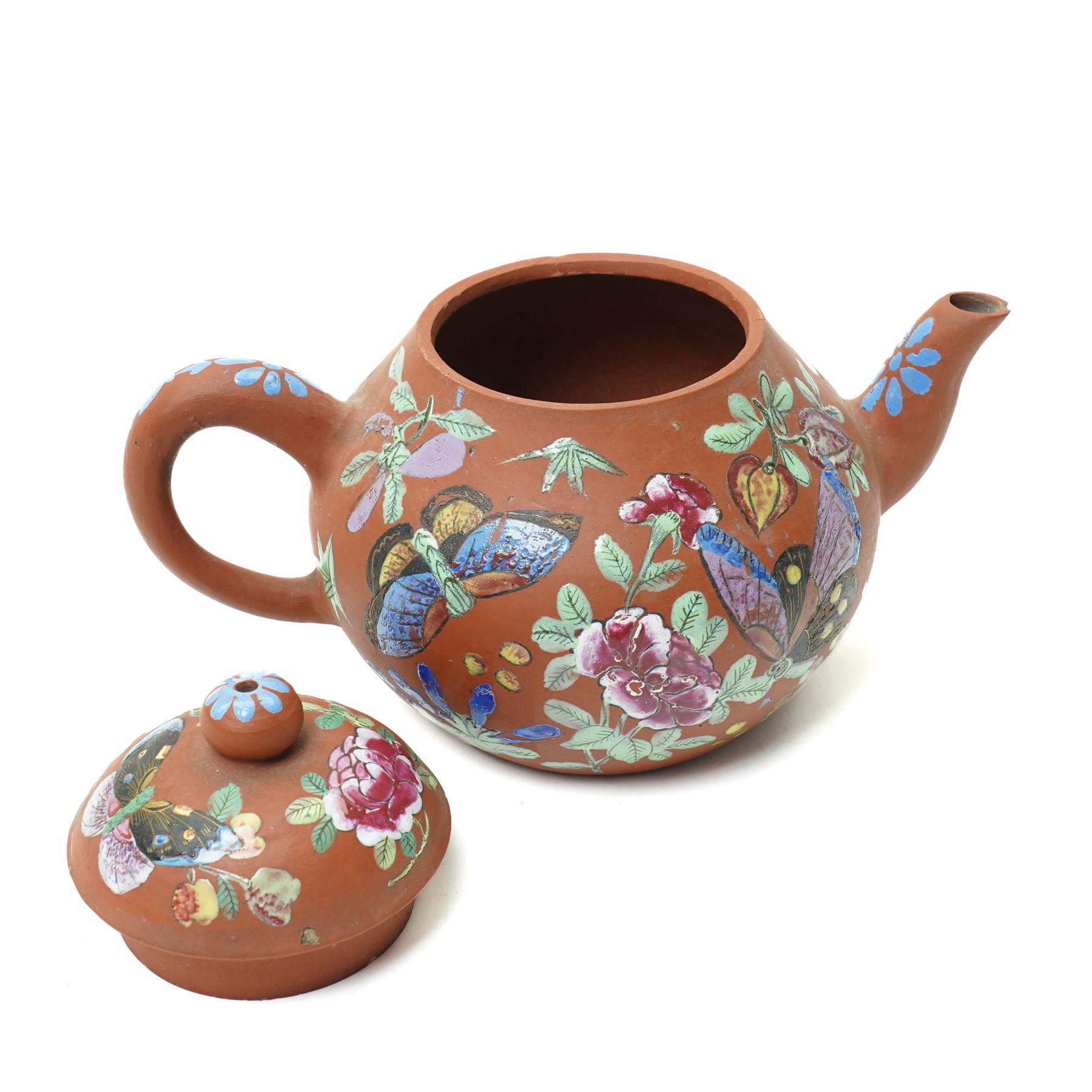 Pair of 18th century Chinese famille rose plates, painted profusely with flowers, D23cm; together with a Yixing teapot, painted with butterflies, H12cm (3)
