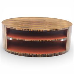 Toby Winteringham - Mid 20th century zebra wood coffee table, oval top with book matched striped veneers over two open tiers painted red, the curved end supports and continuous plinth base veneered to match, recessed plinth base 