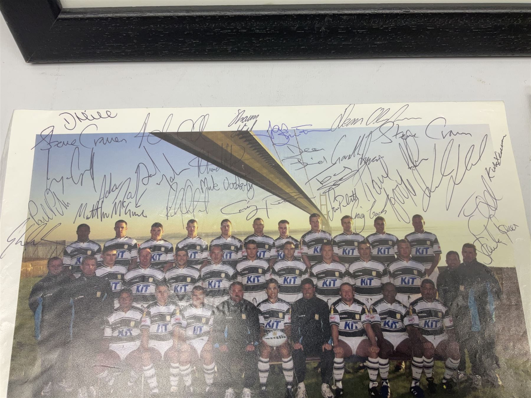 Hull F.C. memorabilia; Clive Sullivan 1986 memorial game programme, Open Evening 1994 programme with multiple player signatures, 'Old Faithful' 45rpm record, Wembley rosettes, 2000 team poster with facsimile signatures, framed print 'Farewell to the Boulevard 1895-2002', fully signed team photograph, various booklets, CD, DVD etc; and a folder containing the Merlin Rugby League card collection