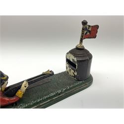 Very rare 19th century John Harper & Co. mechanical cast-iron money box, registered number 33821 patented 1885, inscribed on metal plaque 'Wimbledon Bank', based on the Queen's Trophy for shooting at Wimbledon, depicting a British Infantry man in red tunic and blue trousers lying on the ground using a gun to fire a brass coin launcher into a pill box with removable moving flag above L30cm