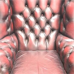 Queen Anne style Chesterfield wing backed armchair, upholstered in deep buttoned Ox blood leather, cabriole legs, W84cm