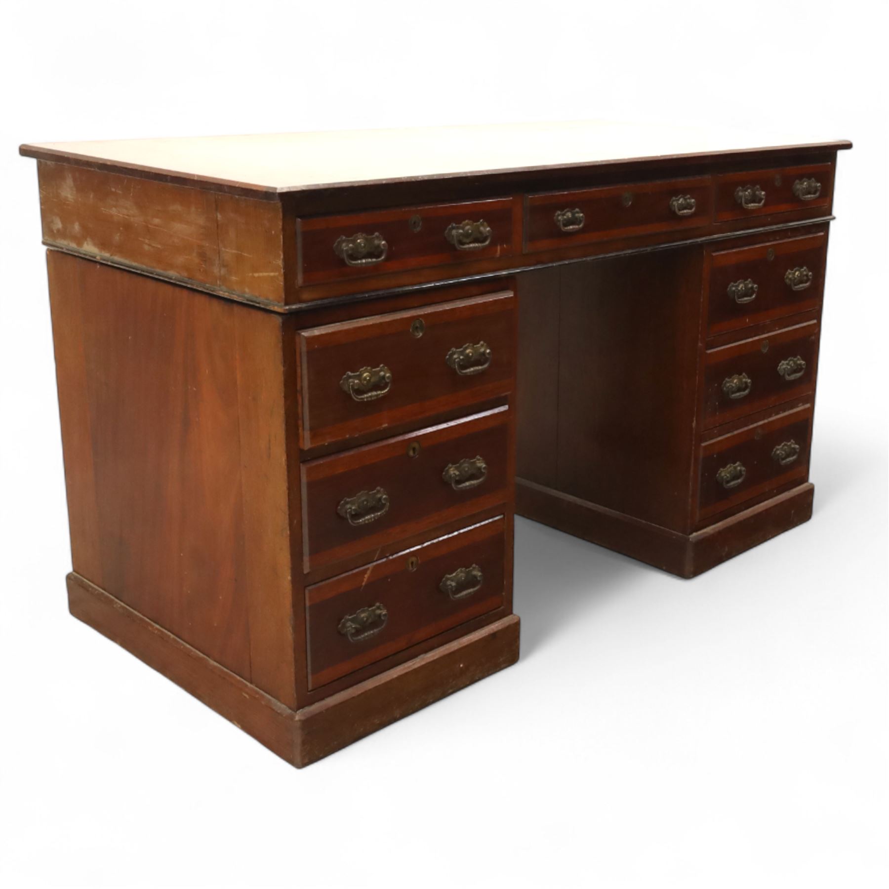 Early 20th century Indian hardwood pedestal desk, rectangular top with moulded edge over three frieze drawers, twin pedestals each fitted with four drawers, brass pierced swing handles and brass escutcheons, upon plinth bases  
