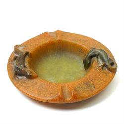 Amalric Walter (1870-1959) and Henri Berge (1868-1936), Nancy, France, circa 1920, pate de verre, Salamander ashtray, bearing moulded mark 'A Walter Nancy' and incised mark 'Berge sc.', D12cm

Note: Almaric Walter, born in Sèvres near Paris, exhibited at the Salon des Artistes Françaises in 1895 and 1903, and in 1908 moved to Nancy where he established his own workshop within the Daum glassworks. There he worked closely with Daum designers, including Henri Bergé. This ashtray is an example of Walter’s pâte-de-verre technique.

Provenance: From the collection of Andrew Chichester Everitt.