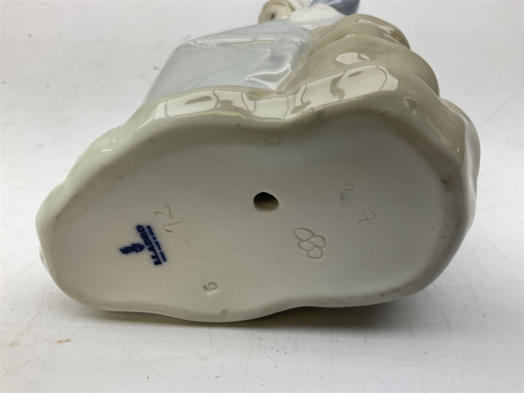 Four Lladro figures, comprising Afternoon Promenade no 7636, Nostalgia no 5071, both with original boxes, Girl with Lilies no 4972 and Madonna no 4534, largest example H27cm