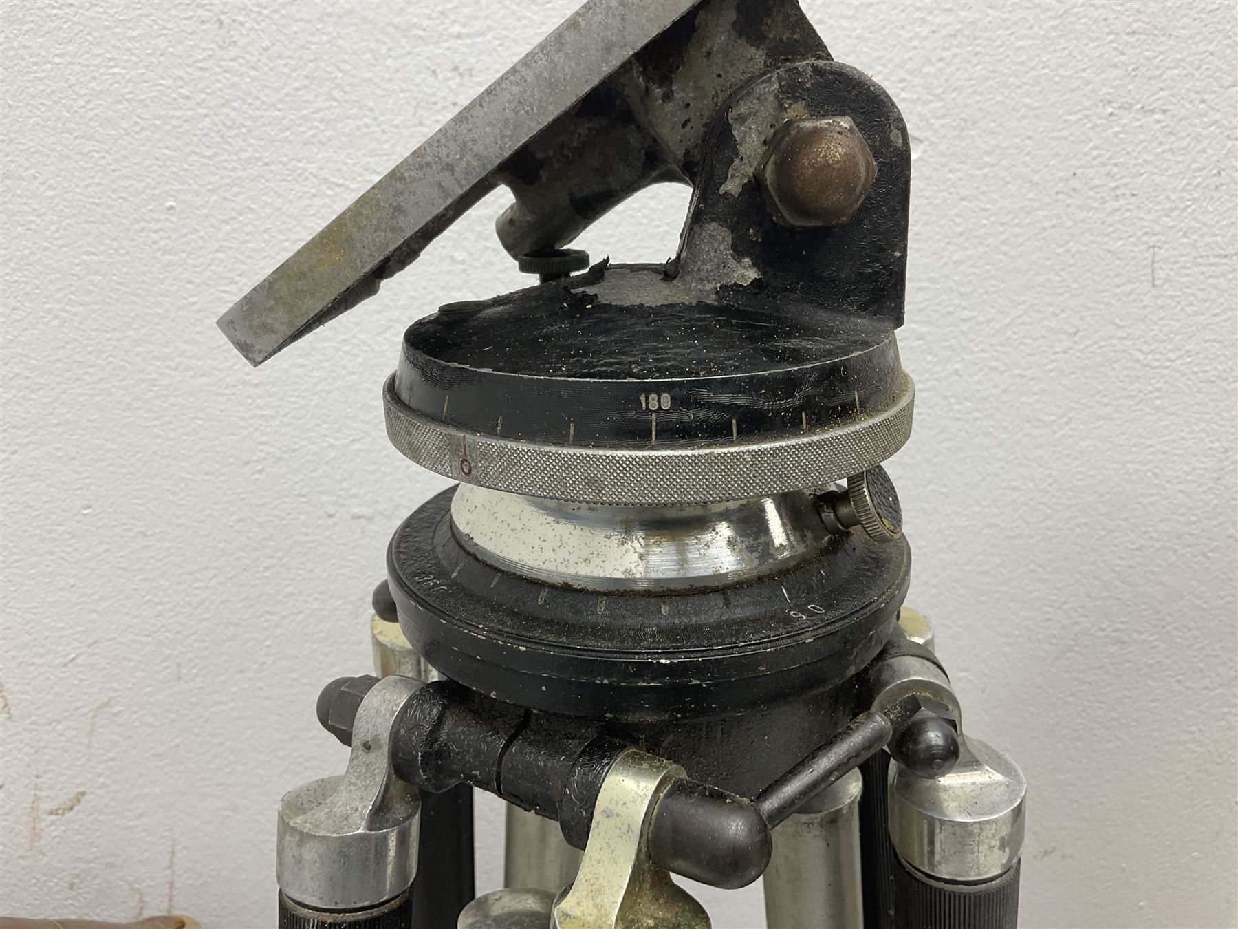 Three wooden adjustable tripods for plate cameras, together with a Linhof of Munchen metal tripod in a canvas case 