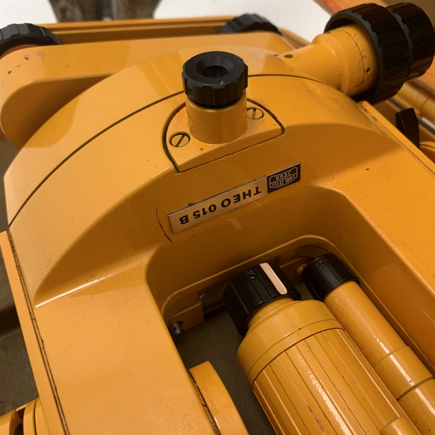 Carl Zeiss Theo 015B orange painted theodolite serial no.251267 in fitted case with accessories; E.R. Watts & Sons London level with black crackled body, serial no.1888, in calf leather carrying case; wooden folding tripod and telescopic measuring staff (4)