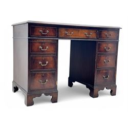 Georgian design mahogany kneehole desk, moulded rectangular top with red gilt-tooled leather writing surface, over an arrangement of nine cock-beaded drawers with brass swan neck handles, on bracket feet