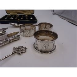 Set of 1930s silver handled fruit knives and forks, for six place settings, the handles decorated in relief with fruiting vines, hallmarked Walker & Hall, Sheffield 1934, together with a set of six 1920s silver egg spoons, with pin prick engraving to handle, hallmarked Thomas Bradbury & Sons Ltd, Sheffield 1929, in fitted case, three silver napkin rings, to include a pair, of octagonal form, with floral engraving, hallmarked John Rose, Birmingham 1951 and two silver souvenir spoons
