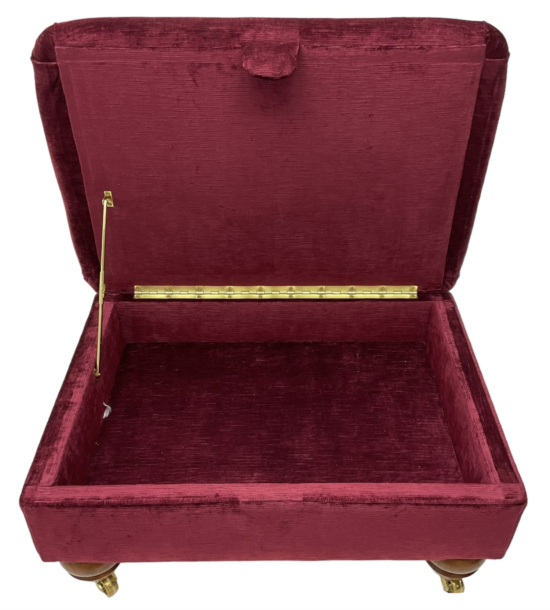 Duresta - traditional shape armchair upholstered in burgundy red velvet, on square tapering front supports (W88cm, H85cm, D103cm); together with a matching rectangular footstool with hinged seat, on turned feet with brass castors (73cm x 54cm, H38cm)