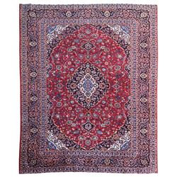 Large Kashan crimson ground carpet, central indigo medallion with stylised floral motifs, ...
