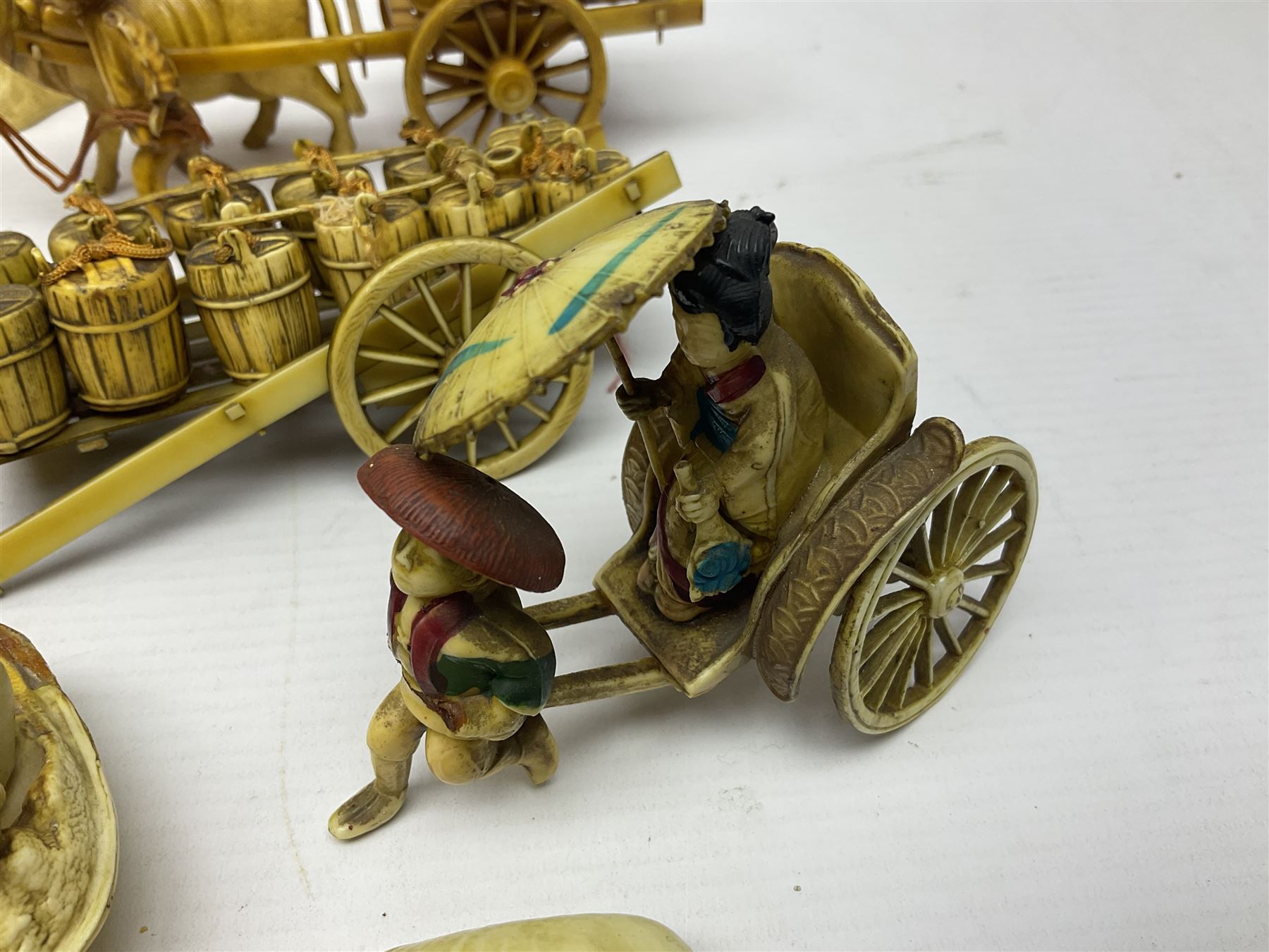 Collection of Japanese celluloid figures, including Rickshaw groups, fishing scene, oxen etc 