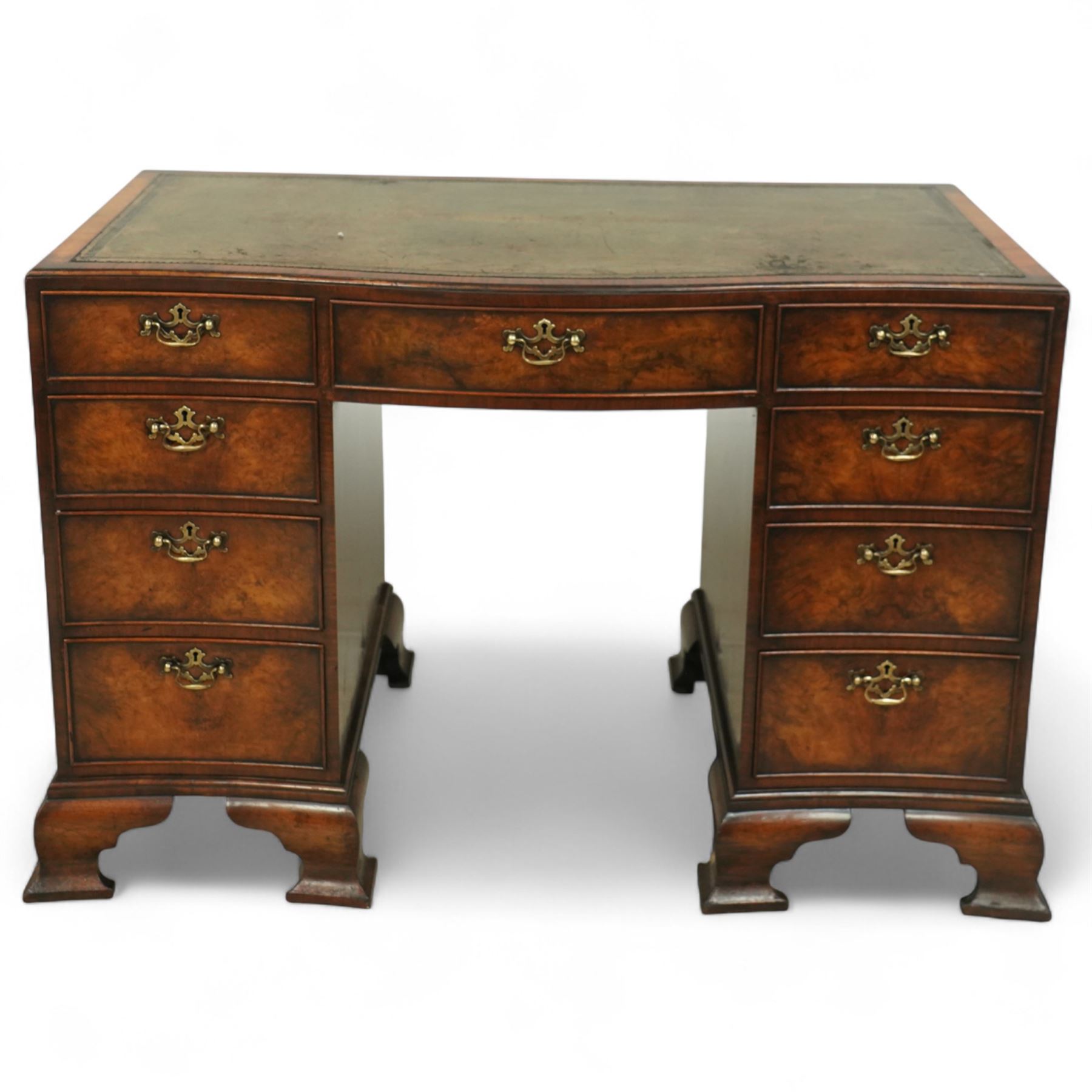 Early 20th century inlaid mahogany pedestal kneehole desk, rectangular top with inset tooled leather writing surface, over an arrangement of nine drawers with brass swan neck handles, on ogee bracket feet