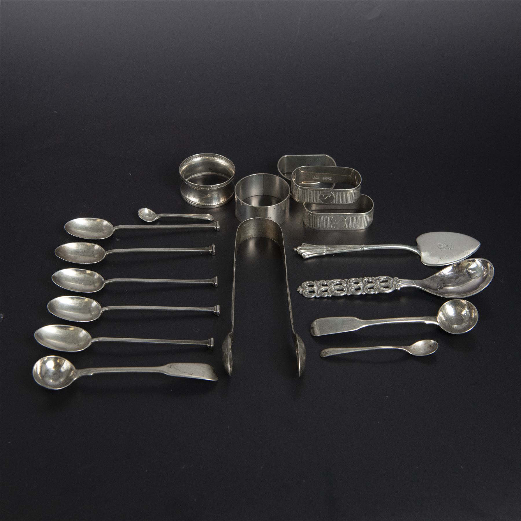 Five silver napkin rings, including pair of 1930s oval examples, with engine turned decoration with engraved initial, together with a collection of silver flatware, including Norwegian spoon, pair of Fiddle pattern mustard spoons, five seal top coffee spoons, etc, all stamped or hallmarked