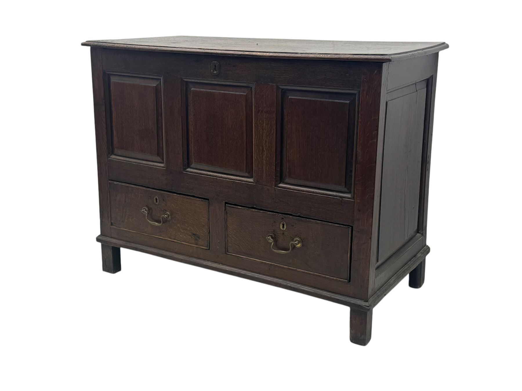 Early 18th century oak mule chest, hinged rectangular top above three recessed panels and two drawers, each fitted with brass drop handles, open interior fitted with candle box compartment, raised on square supports