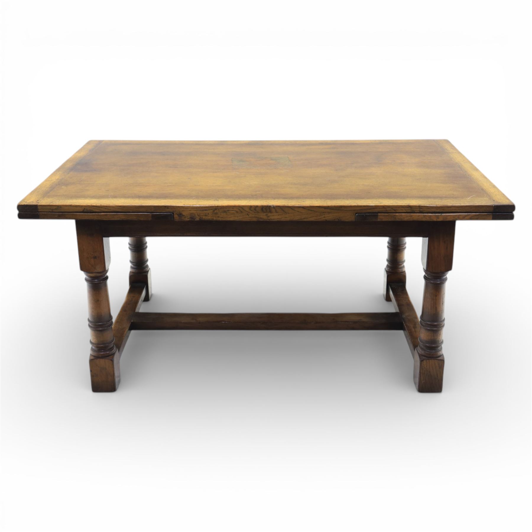 Titchmarsh & Goodwin - stained oak draw leaf dining table, raised on turned supports with H-stretcher, extends to 273cm