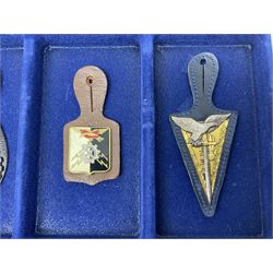Twelve French military metal badges mounted on leather fobs including Legion, Artillery, Parachutist, Air Force, Infantry etc