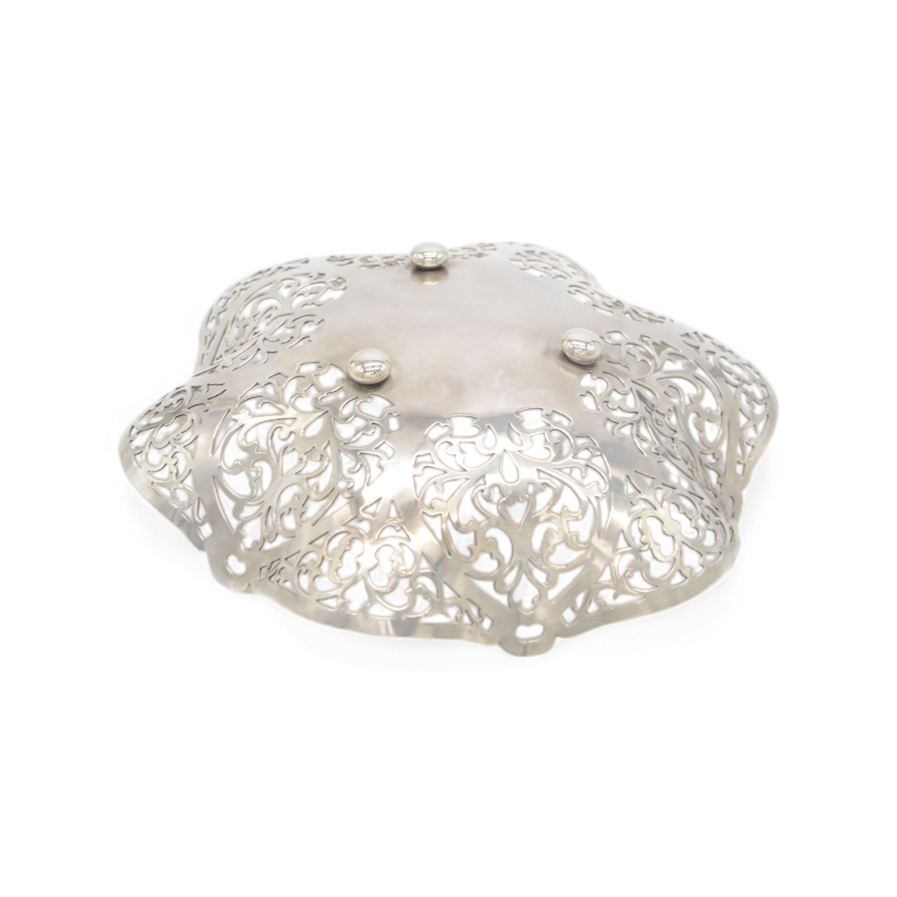 Mid 20th century silver bowl, of hexagonal form with scrolling pierced sides, upon three bun feet, hallmarked W I Broadway & Co, Birmingham 1962, W18cm