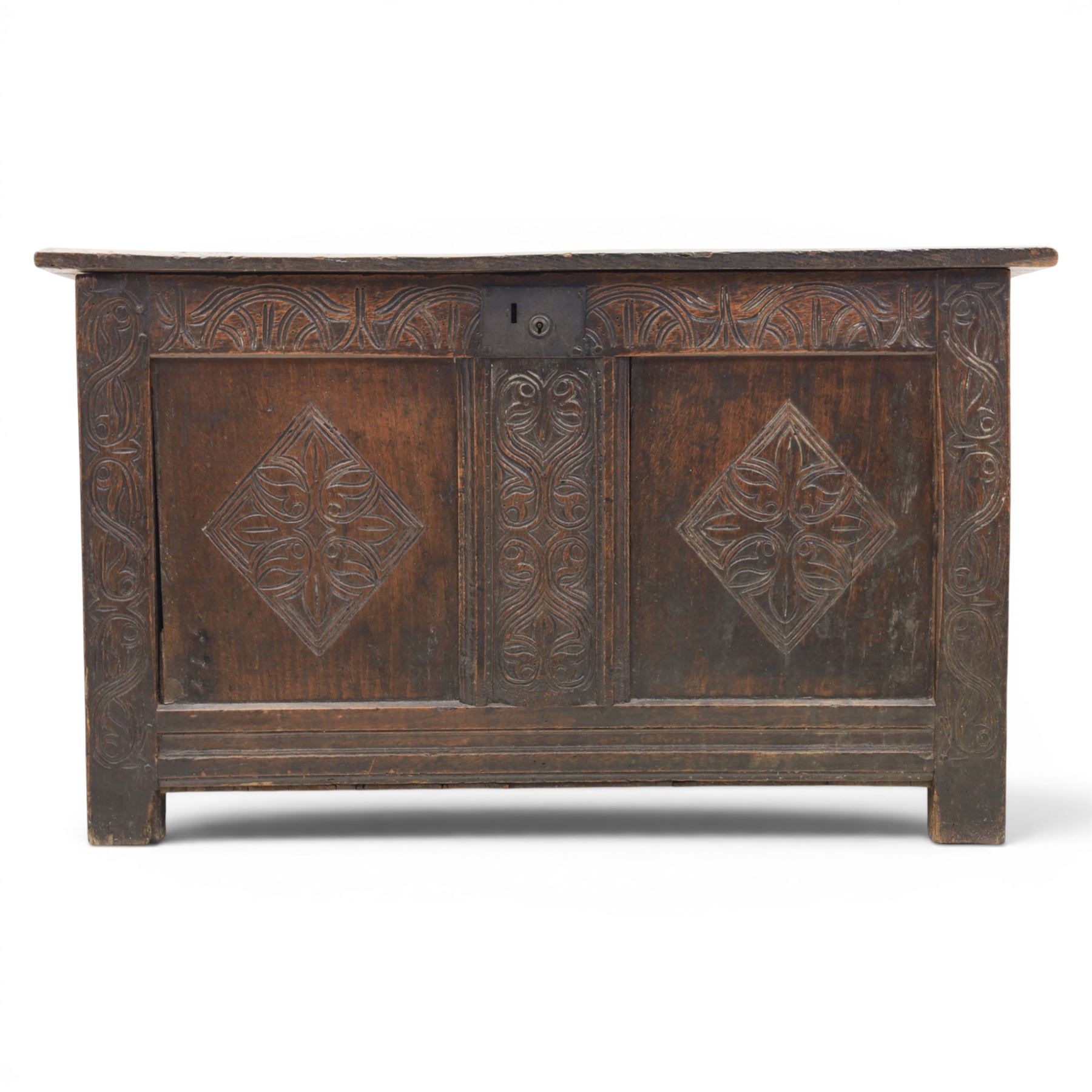 18th century oak coffer with carved frieze and rails, rectangular plank top with iron strap hinges, raised on stile supports