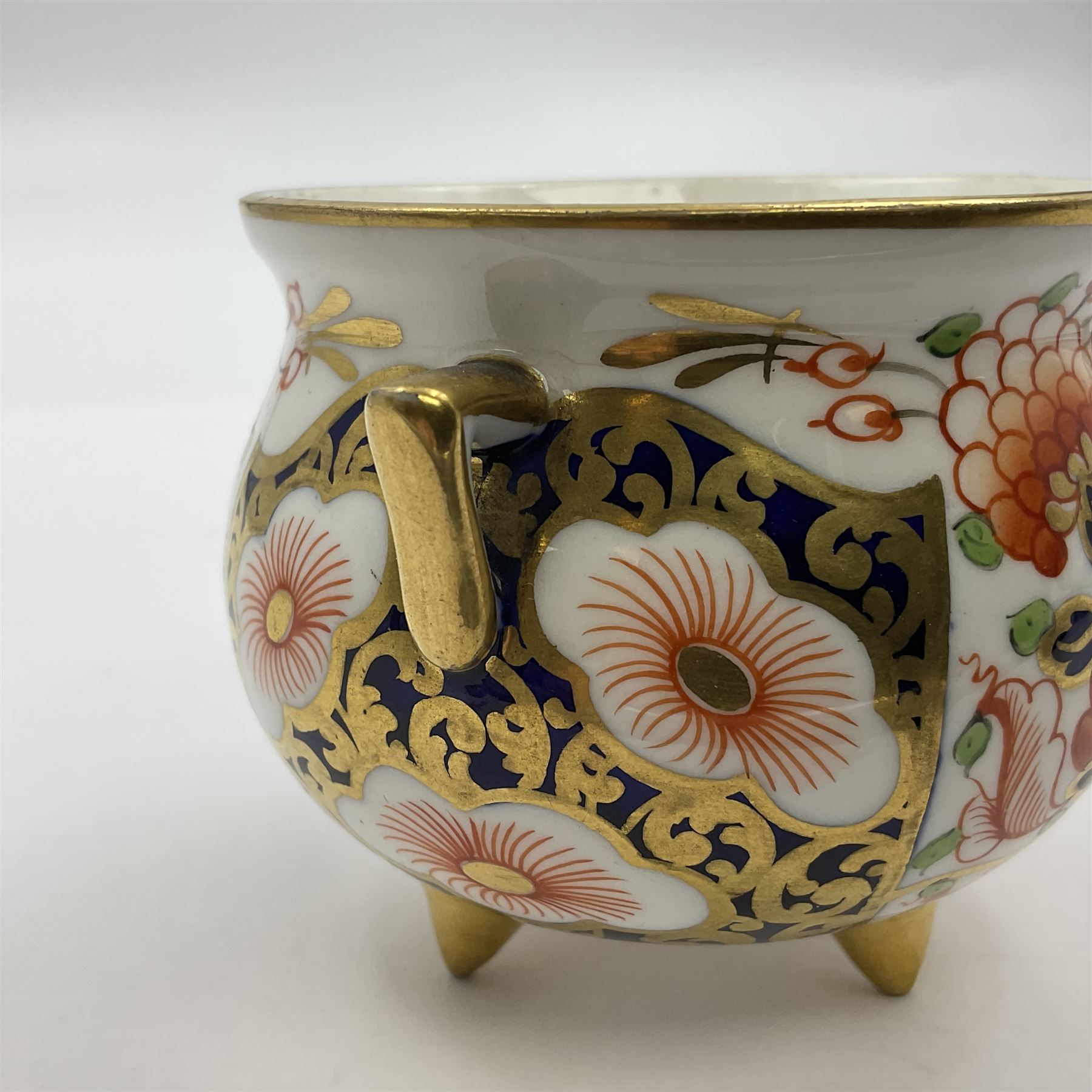 Group of Crown Derby and Royal Crown Derby Imari pattern miniatures, including mid 19th century Stevenson and Hancock cauldron, with painted mark beneath, H5.5cm, a near pair of early Royal Crown Derby scuttles, decorated in the 6299 pattern, each with printed and painted marks beneath including illustration date codes for 1913 and 1922, tallest 6.5cm, and a further early 20th century Royal Crown Derby scuttle, decorated in the 6299 pattern, with printed and painted marks beneath including illustration date code for 1922, H5.5cm, (4)
