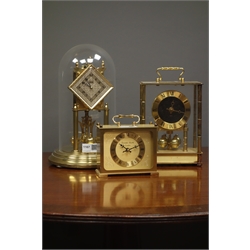  Late 20th century 'Kundo' anniversary torsion clock with lozenge shaped dial, under dome (H29cm), another torsion clock and a quartz clock in polished metal case  