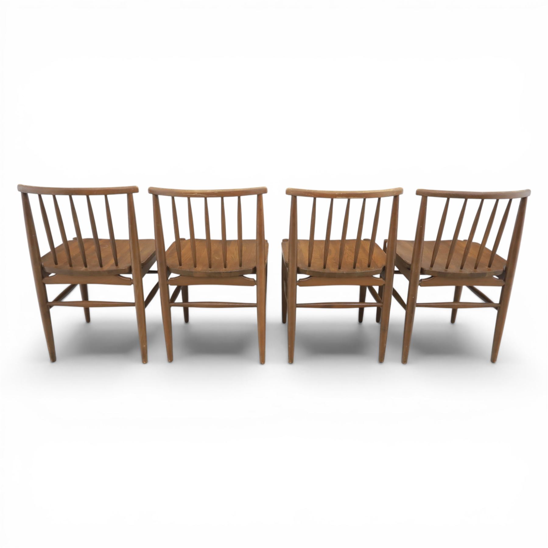 Ensign - Mid-20th century elm extending dining table, with fold out leaf, bow ends and sides; and four low stick back chairs, labelled Ensign Bristow & Townsend Ltd, extended 168cm