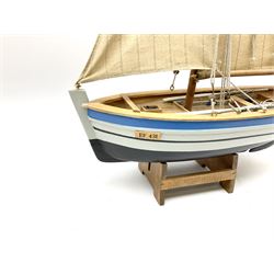 Wooden model of RMS Titanic, on a fixed black stand bearing plaque inscribed 'Titanic 1912', L54cm, H22cm, together with model of a sloop, gaff rigged on stand bearing plaque inscribed 'Sloop' L32cm, H42cm; and model of a fishing trawler on a stand bearing plaque inscribed 'Chalutier' L35cm, H28cm (3)