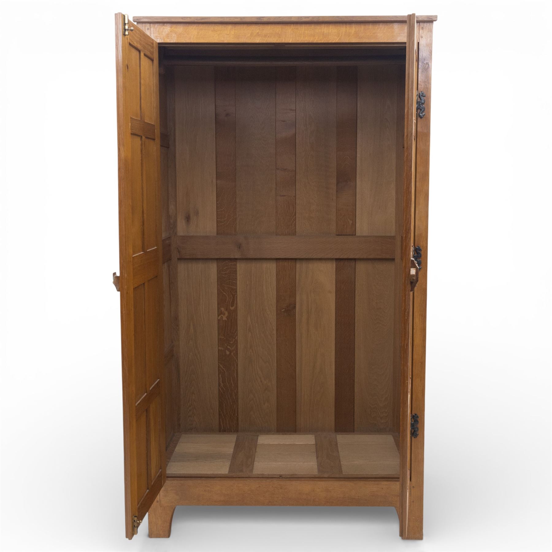 Acornman - oak adzed panelled double wardrobe, with wrought iron hinges and carved oak latch revealing a single clothes rail, with signature carved acorn to top left, by the workshop of Alan Grainger, Brandsby