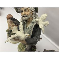 Three Capodimonte figures, to include The Kind Heart Man, modelled by Cortese as a tramp with two doves, The Young Falconer by Maria Angela and another modelled as a tramp darning his socks, all with printed marks, tallest H39cm