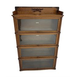 Mid-20th century oak 'Globe Wernicke' library stacking bookcase, four sections each with hinged and sliding glazed doors, shaped fronts with reeded uprights 