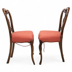 Set of four Victorian walnut balloon back chairs, with a carved and pierced back splat with foliate scrolls, serpentine seat upholstered in a diamond pattern fabric, raised on cabriole legs 