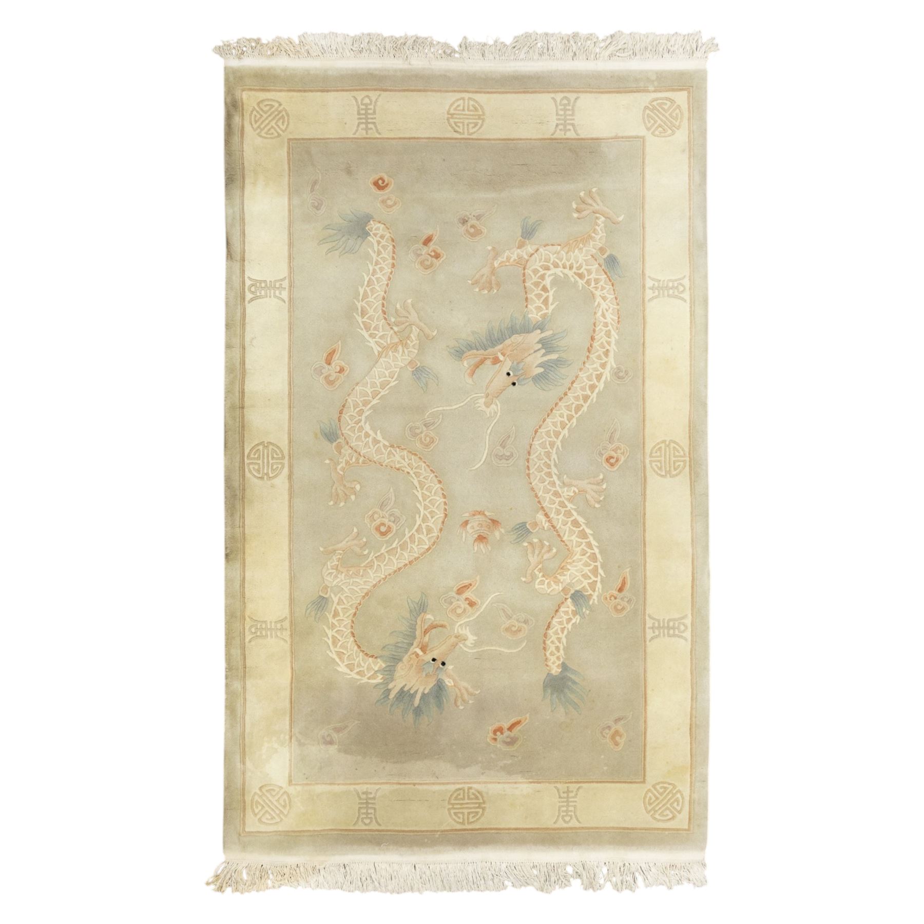 Chinese wool rug, the pale grey central field decorated with two stylised dragons, flaming pearls and cloud scrolls, within a cream border of shou medallions and geometric motifs, with cotton fringe ends