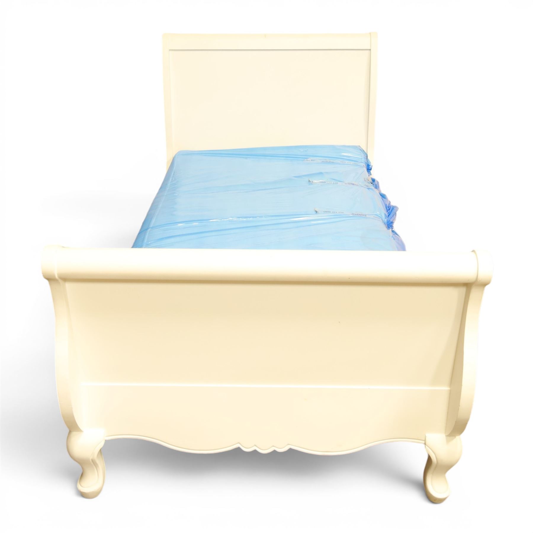 Modern white painted single sleigh bed frame and mattress, with scrolled head and footboard with foliage detail