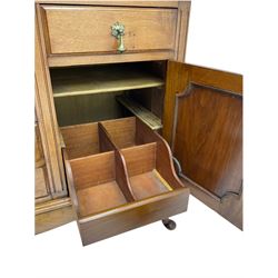Late Victorian walnut mirror back sideboard or dresser, the raised back fitted with two curved and lead glazed cabinets, central arched bevelled mirror, the sideboard with break bowfront, fitted with six drawers and two cupboards, the cupboard doors panelled and carved with scrolls, shell and plant motifs, shaped apron with cabriole feet
