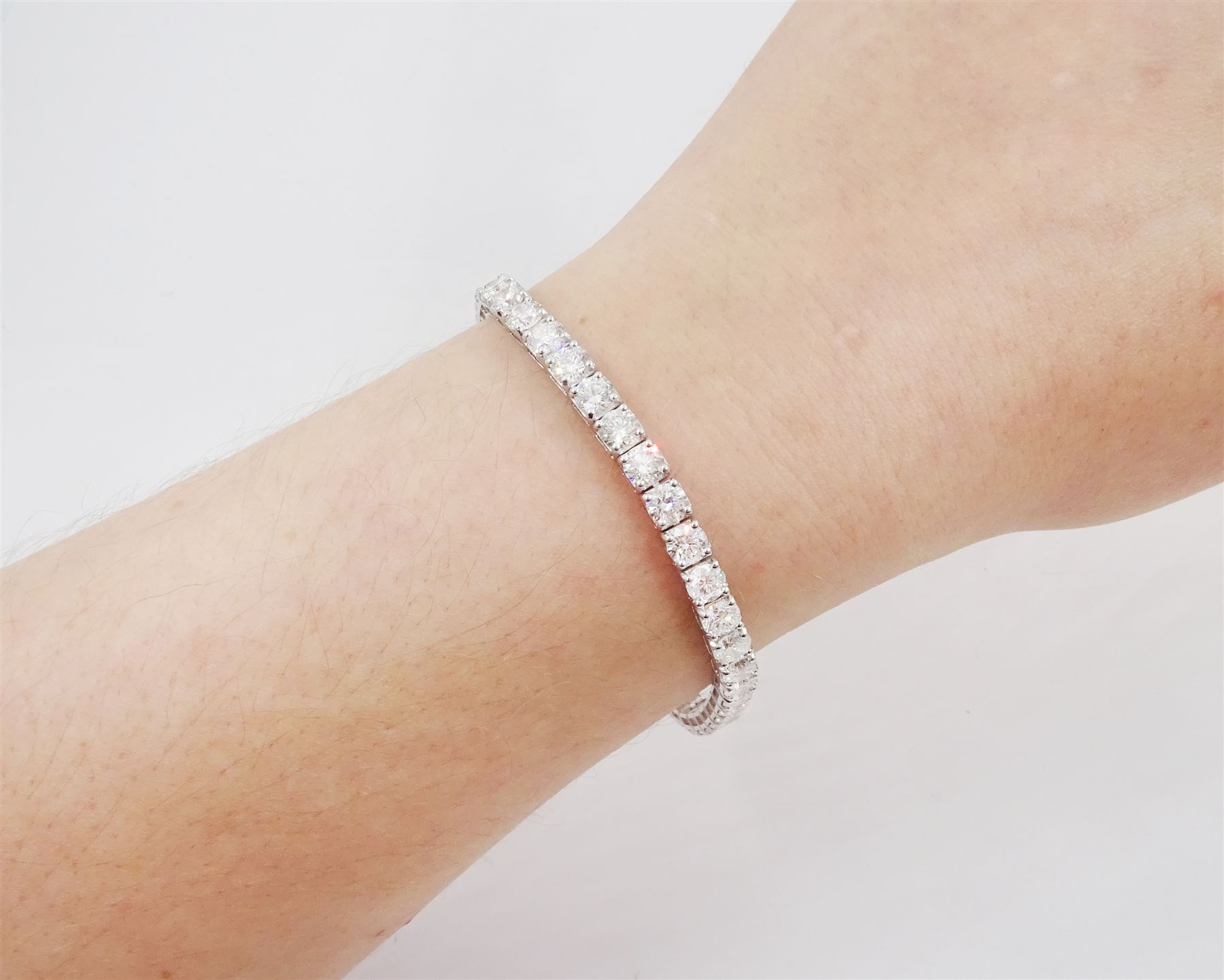 18ct white gold diamond bracelet, forty round brilliant cut diamonds , in a four claw setting, stamped 18K, total diamond weight 12.26 carat, with World Gemological Institute report