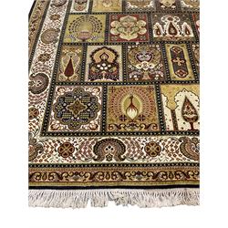 Persian design carpet, the field with various size tiles decorated with stylised plant motifs, floral urns and peacocks, the main border decorated with repeating foliate motifs and trailing flower heads