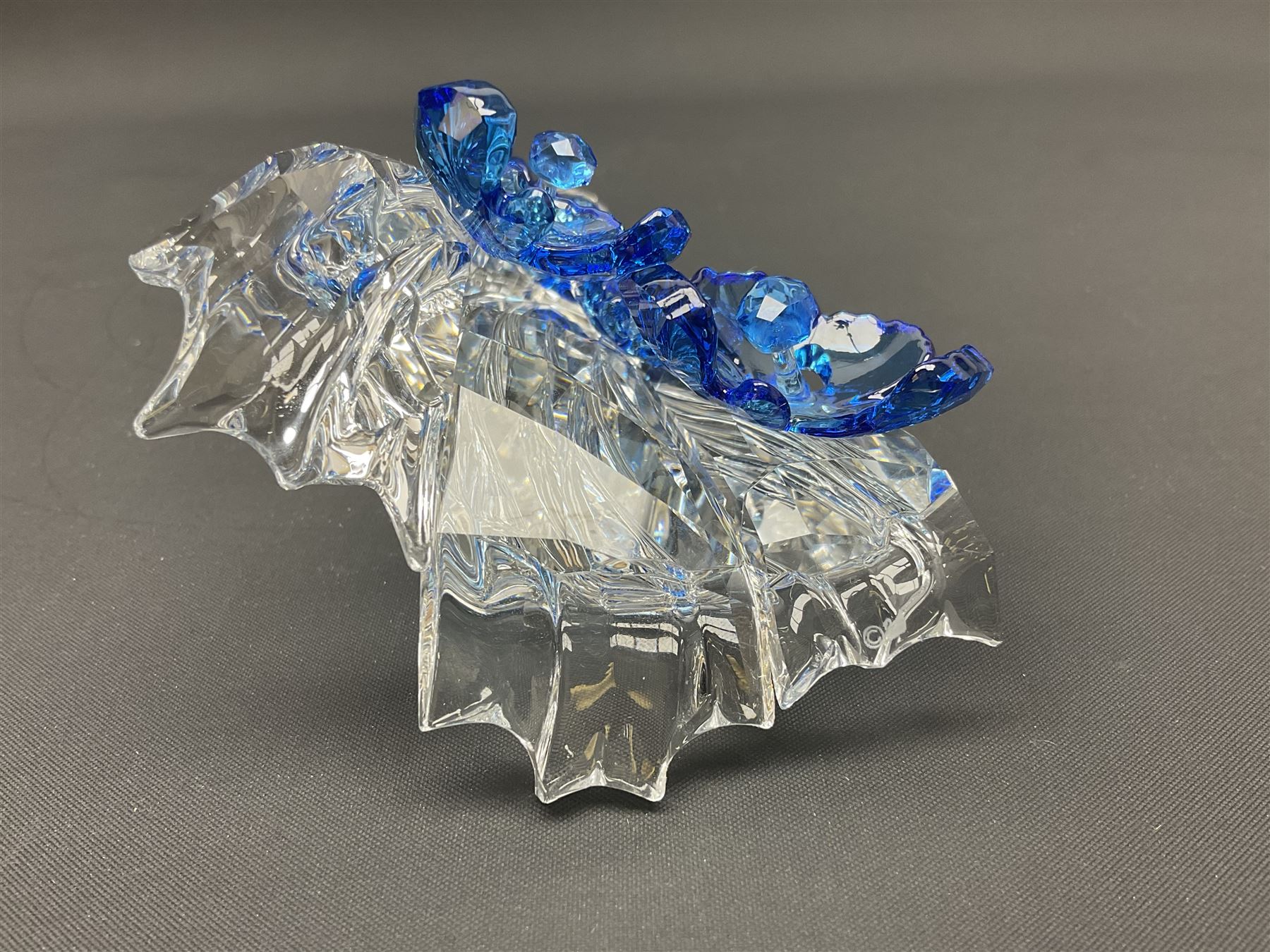 Swarovski Crystal animals, comprising white peacock, the tail with cascading blue flowers, perched eagle with yellow beak, ibex with frosted crystal horns and unicorn with frosted crystal horn, tallest H13cm