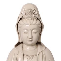Large Chinese blanc de chine figure of Guanyin, depicting the goddess stood upon a lotus leaf with one hand raised, with potters seal mark to the reverse, H75cm